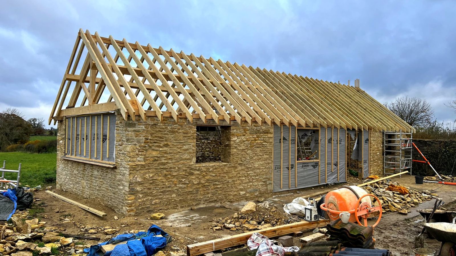 New rafters and an oak gable truss going up on old stone walls