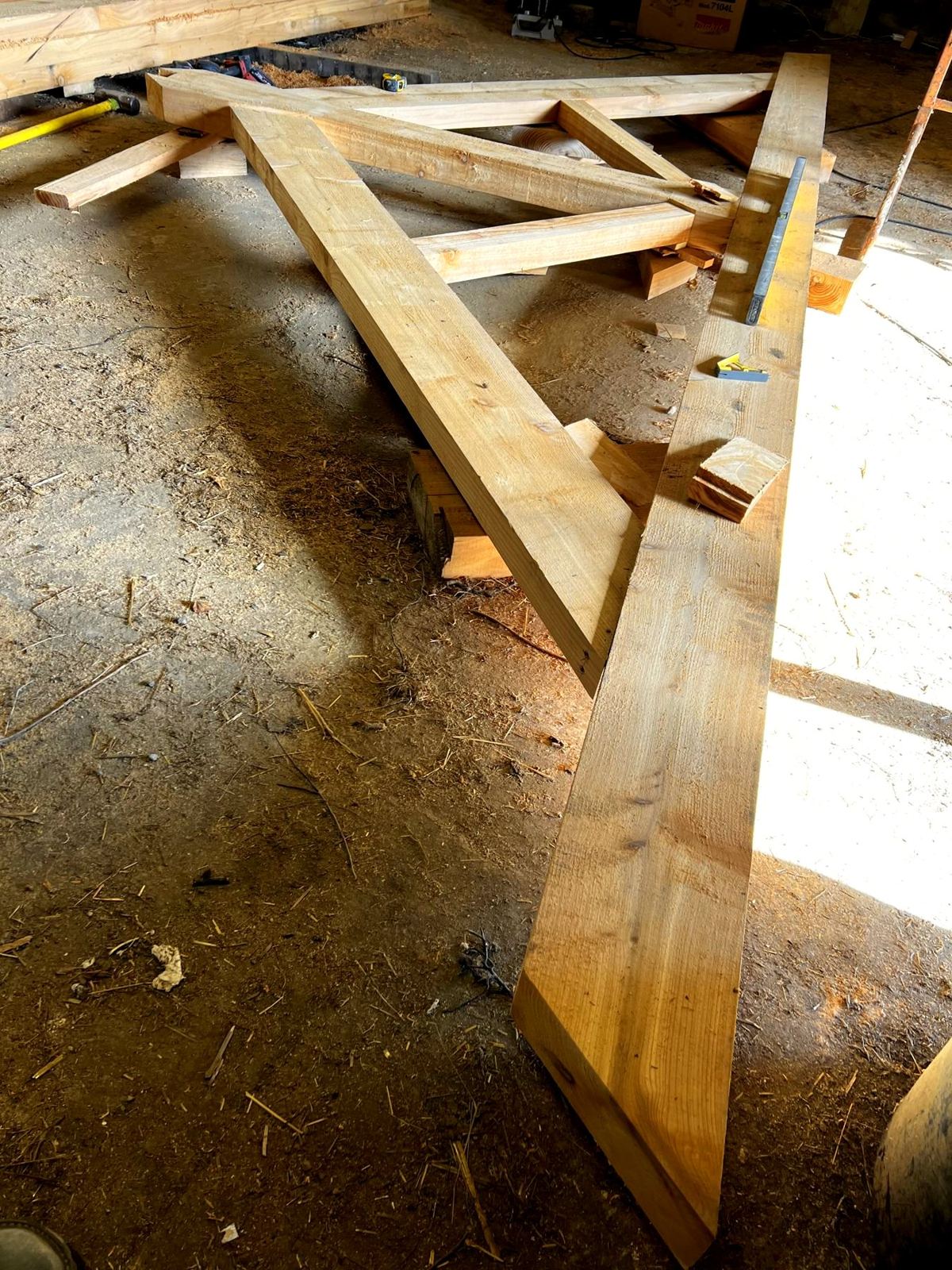 A roof truss being made in the workshop